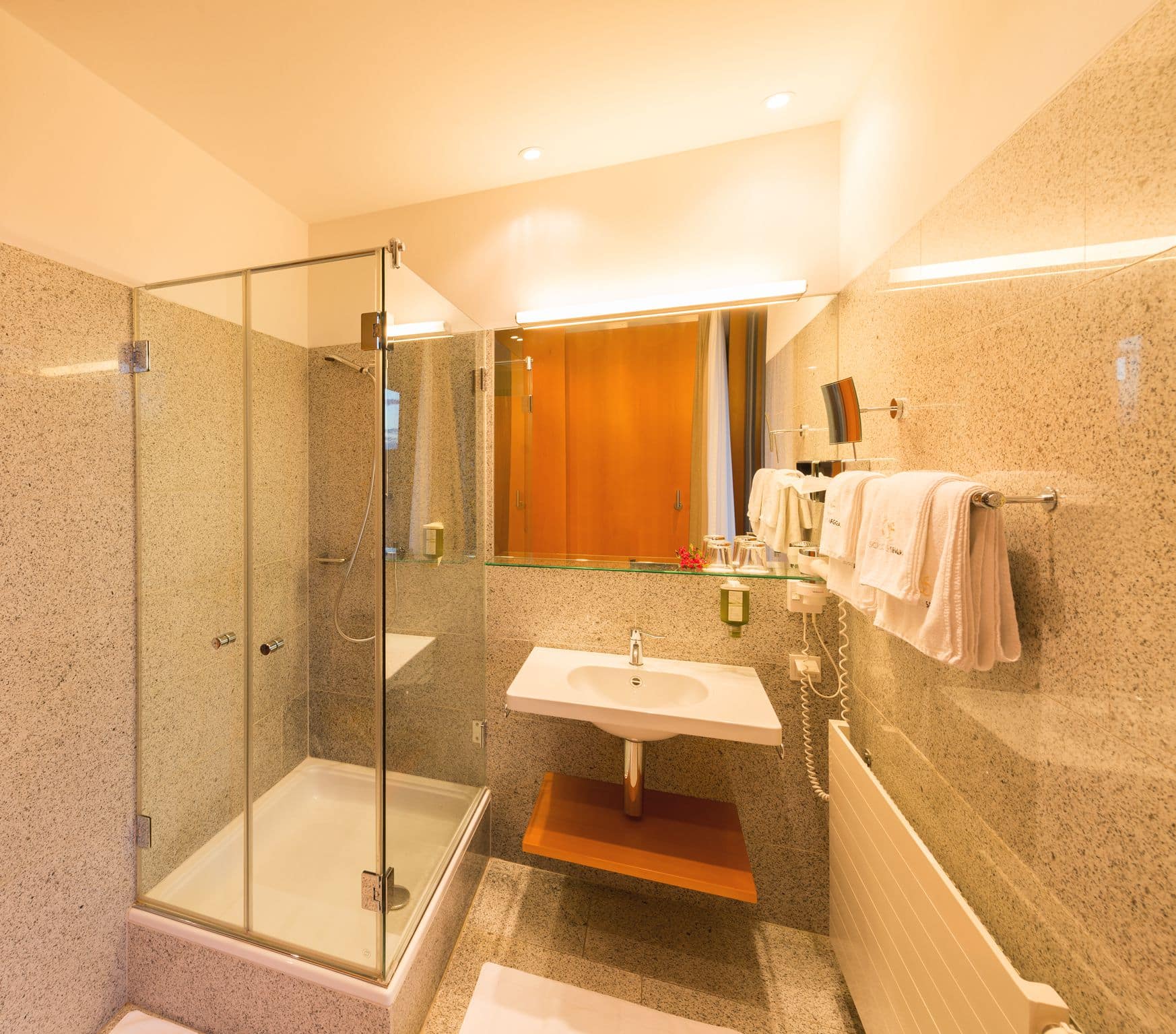Modern comfort double room bathroom with shower, bathroom sink, mirrow and tower holder