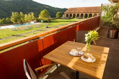 Balcony superior double room with view of the pool lawn, pool and orangery